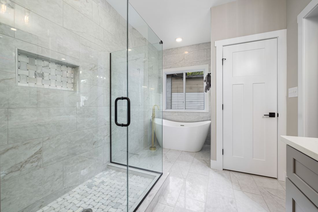 Walk-in shower and marble tiling in a finished bathroom renovation